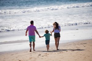 Picture of a family walking on the beach.
