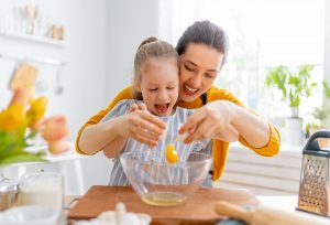 Picture of a mother and daughter cooking together.