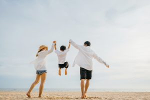 Picture of a happy family walking on a beach.