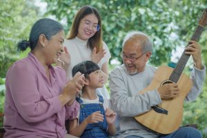 Picture of a grandmother, a grandfather, and two grandchildren singing together.